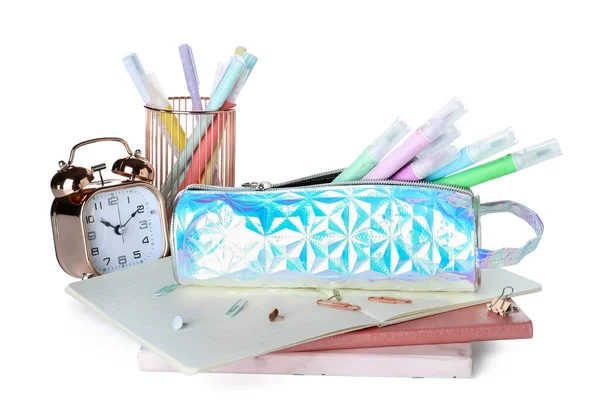 Holographic pencil case with school stationery and alarm clock on white background