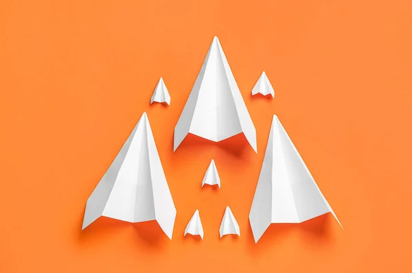 Paper planes on orange background