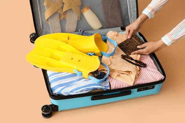 Woman Putting Passport Suitcase Clothes Beach Accessories Color Background — Fotografia de Stock