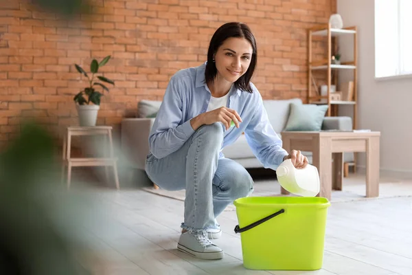 Young Housewife Pouring Detergent Bucket Home — Stockfoto