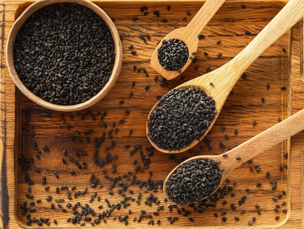 Wooden Board Bowl Spoons Black Sesame Seeds Closeup — Stock Fotó