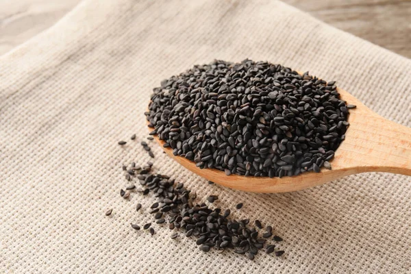Wooden Spoon Black Sesame Seeds Fabric Background Closeup — Stock Fotó