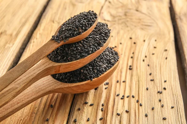 Spoons Black Sesame Seeds Wooden Background Closeup — Stock Fotó