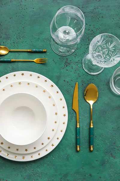 Elegant Table Setting Plates Cutlery Glasses Green Background — Fotografia de Stock