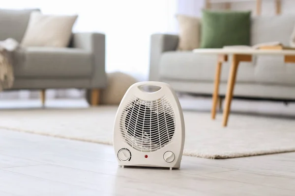 Electric fan heater on floor in living room