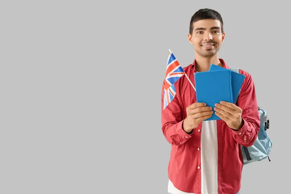 Young Man Flag Books Backpack Grey Background — стоковое фото