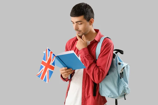 Thoughtful Young Man Flag Reading Book Grey Background —  Fotos de Stock