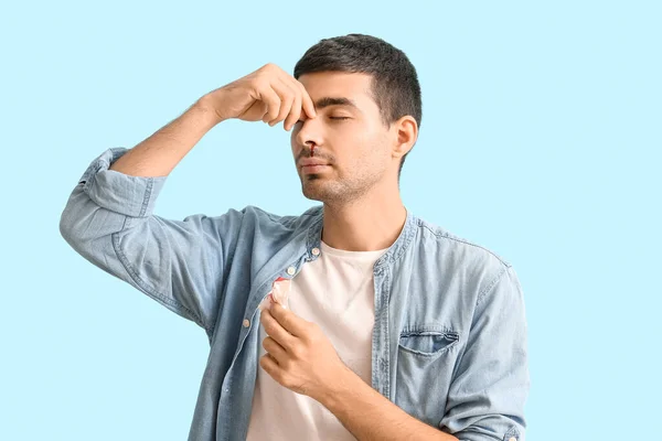 Young Man Nosebleed Tissue Blue Background — Stock Photo, Image