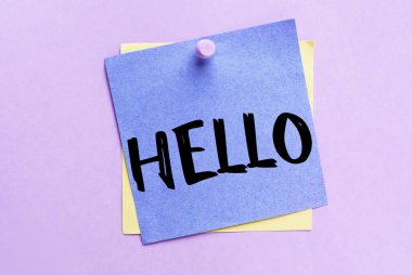 Sticky note with word HELLO on lilac background, top view
