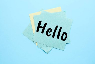Sticky note with word HELLO on light blue background