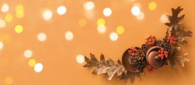 Beautiful autumn table setting on orange background with space for text