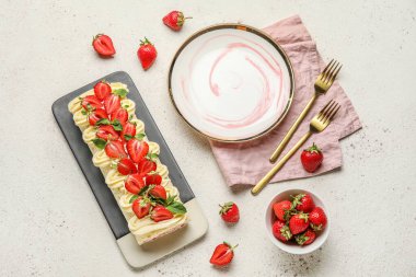 Composition with delicious strawberry roll cake and fresh berries on light background