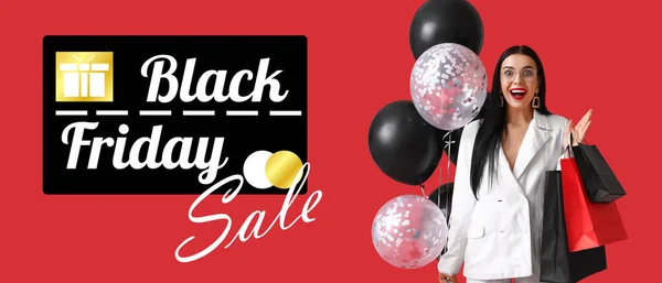 Surprised Young Woman Shopping Bags Balloons Red Background Black Friday — Stockfoto