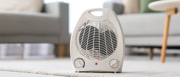 Electric fan heater on floor in living room