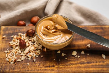 Tahta tahta tahtada bir kase fındık ezmesi, yakın plan.