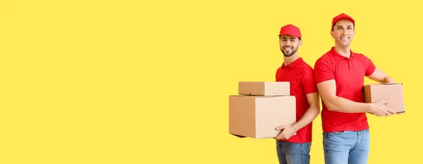 Delivery Men Holding Parcels Yellow Background Space Text — Stock Photo, Image
