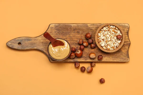 Wooden Board Bowl Tasty Nut Butter Hazelnuts Color Background — Stock Photo, Image