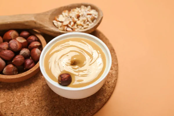 Bowls Tasty Nut Butter Hazelnuts Color Background Closeup — Stock Photo, Image