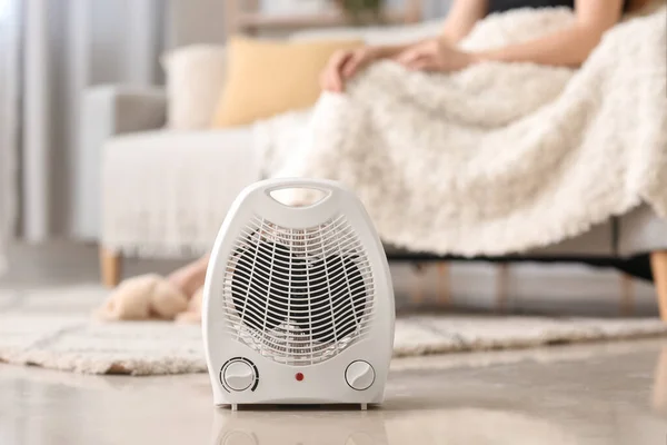 Electric fan heater on floor in living room, closeup