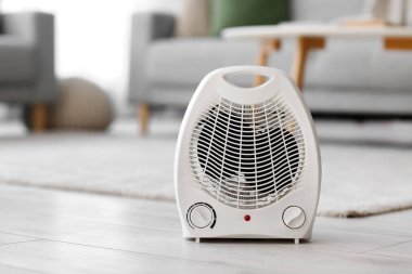 Electric fan heater on floor in living room