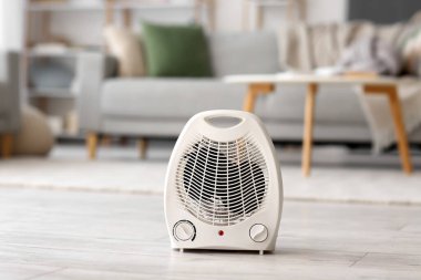 Electric fan heater on floor in living room