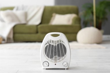 Electric fan heater on floor in living room