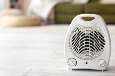 Electric fan heater on floor in living room