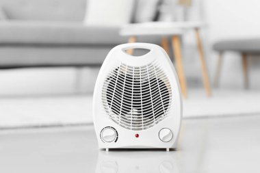 Electric fan heater on floor in living room