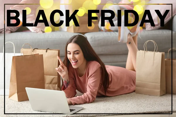 Happy woman with laptop and shopping bags at home. Black Friday sale