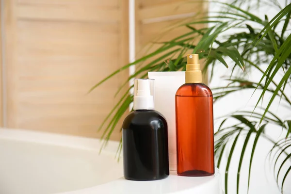 Bottles with cosmetics in bathroom