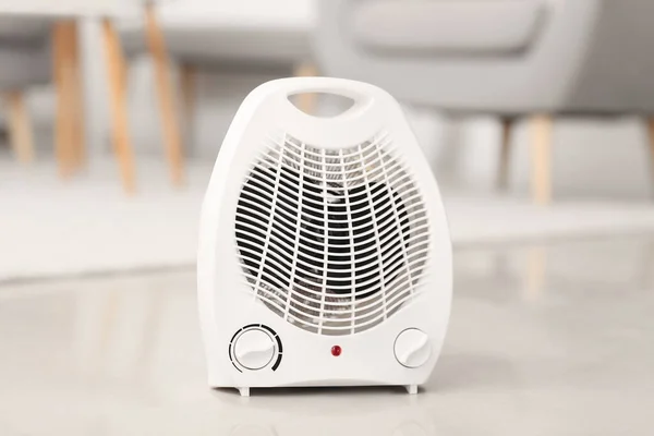 Electric fan heater on floor in living room