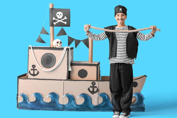Little Boy Dressed Pirate Rope Cardboard Ship Blue Background — Stock Photo, Image