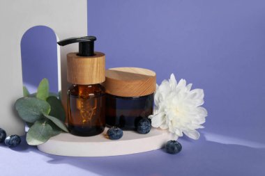 Composition with natural cosmetics and plaster decor on lilac background