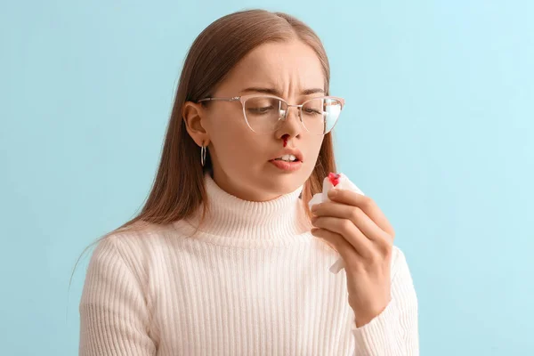 Young Woman Nosebleed Tissue Blue Background Closeup — Stock Photo, Image