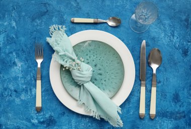 Table setting decorated with gypsophila flowers on blue background