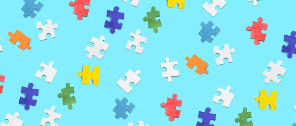Many pieces of jigsaw puzzle on blue background. Pattern for design
