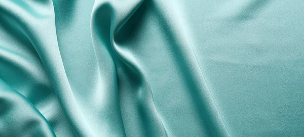 Texture of turquoise fabric as background, top view