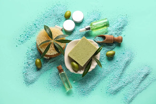 Composition with natural cosmetic products, massage brush and sea salt on color background