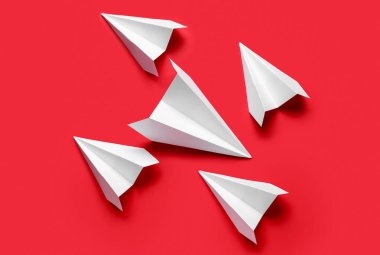 Kırmızı arkaplanda kağıt uçaklar