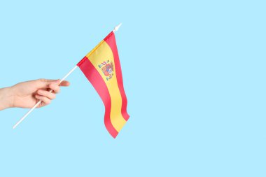 Woman with flag of Spain on blue background
