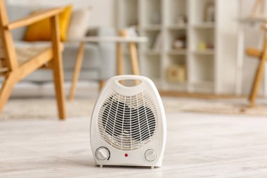 Electric fan heater on floor in living room
