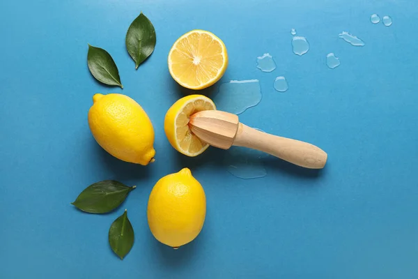 Limones Frescos Con Exprimidor Madera Sobre Fondo Color —  Fotos de Stock