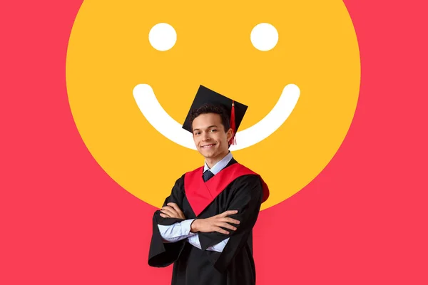 Male graduating student and drawn smile on red background