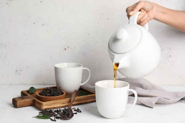 Woman Pouring Hot Black Tea Cup Table — Stock Photo, Image