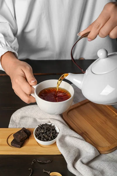 Woman Pouring Hot Puer Tea Dark Wooden Table Closeup — Stock Photo, Image