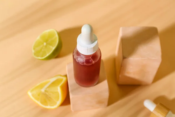 Bottle of vitamin C serum on color background