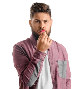 Burnu kanayan ve beyaz arka planda mendili olan sakallı genç bir adam.