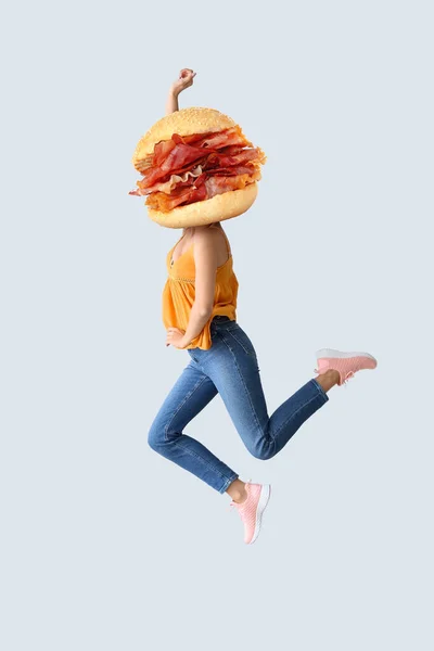 Jumping Woman Tasty Burger Instead Her Head Light Background — Stock Photo, Image