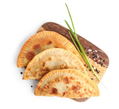 Lezzetli cheburekler, yeşil soğan ve beyaz arka planda biberli pano.