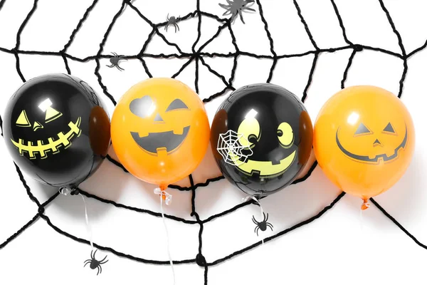 Halloween balloons and spider web on white background